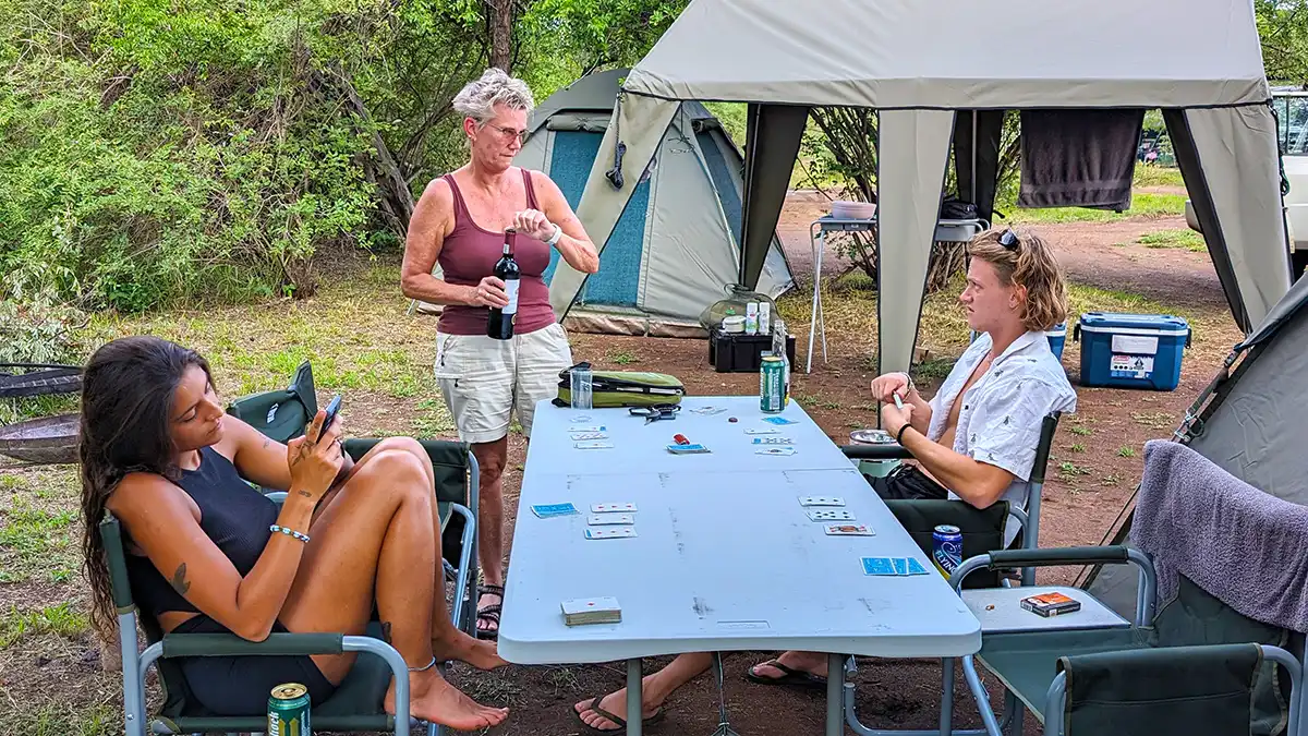 Guests sharing camp life around the table during a Kruger camping safari